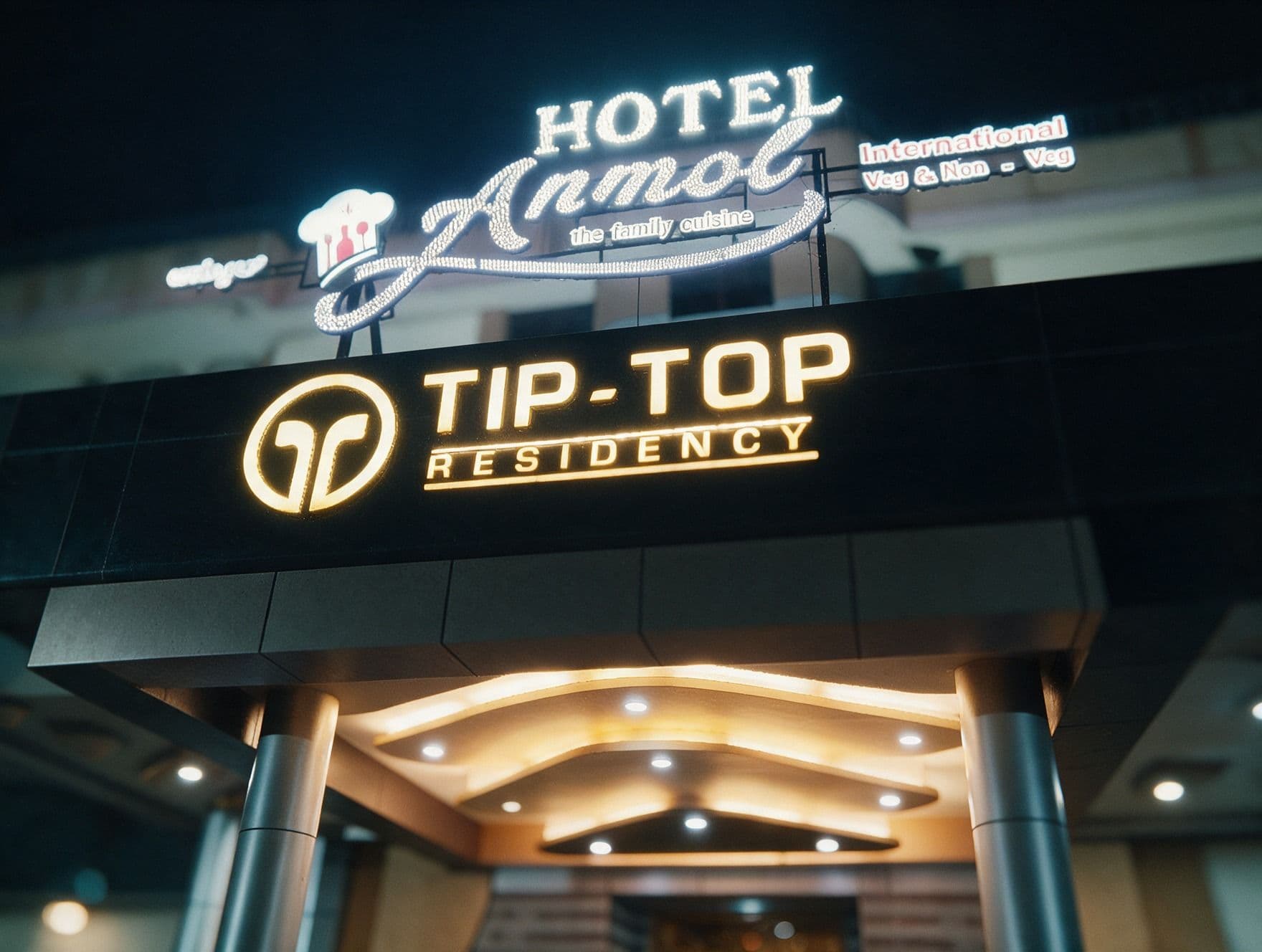 Tiptop Residency illuminated sign at night