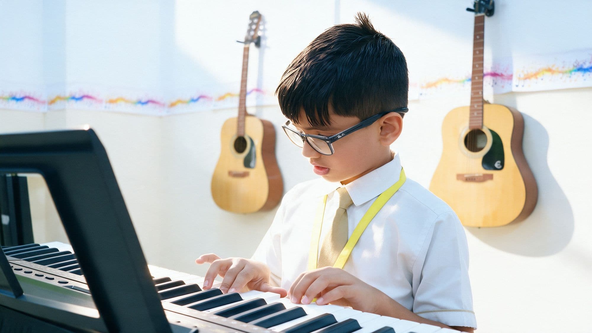 Student practising the keyboard in a music room